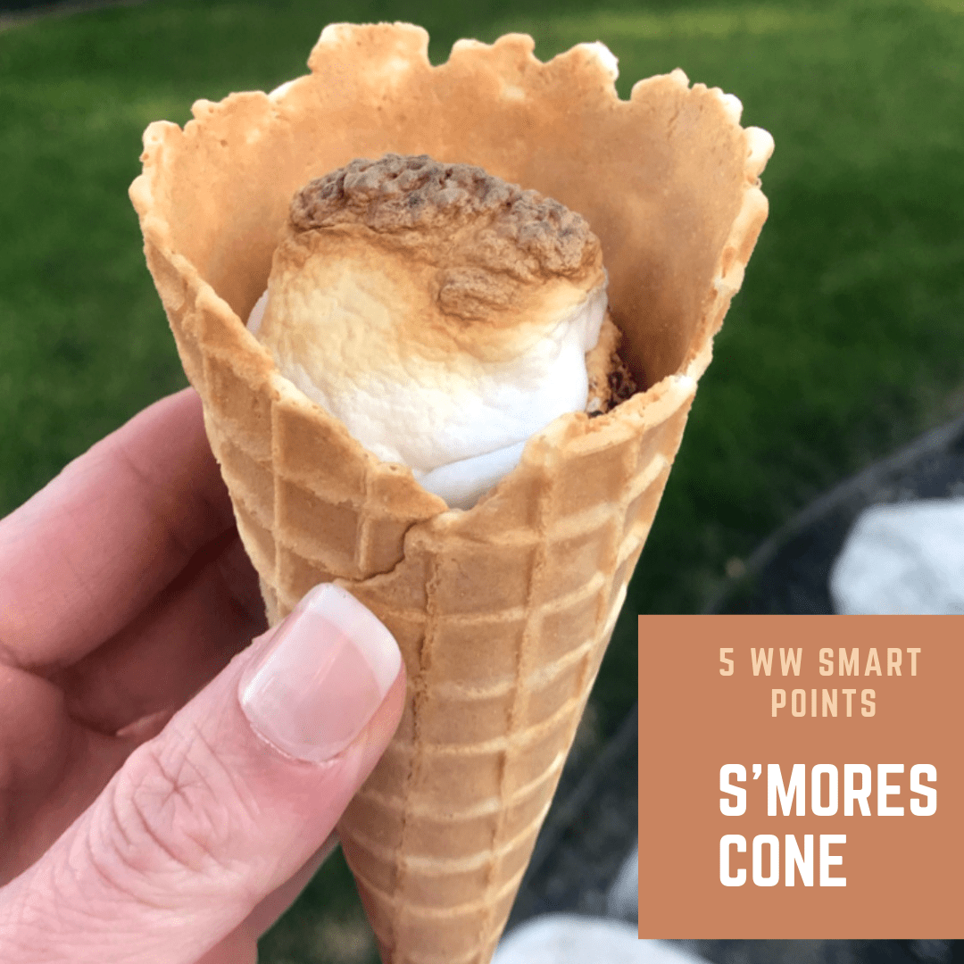 Waffle cone with heart-shaped marshmallows, close-up on a blue