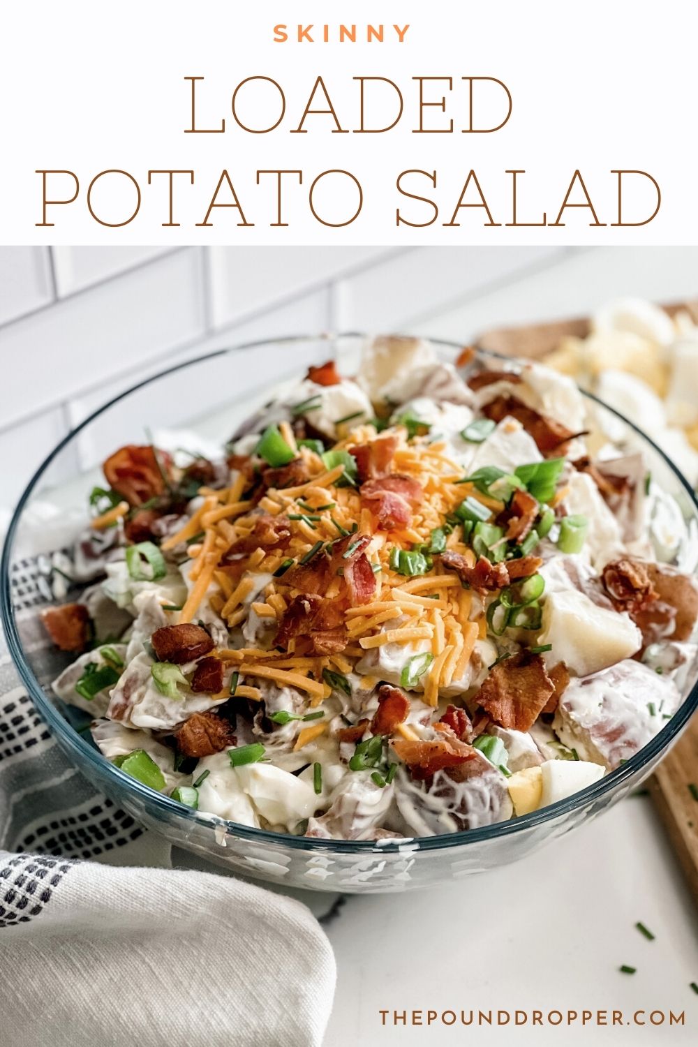 This Skinny Loaded Potato Salad is a healthier version of a loaded potato salad-packed with protein-made with non fat Greek yogurt, light mayo, bacon pieces, green onions, potatoes, and hard boiled eggs!  It's an easy potato salad recipe that has become a staple at our summer picnics, BBQ's, and holiday dinner. This is a MUST have side dish! via @pounddropper