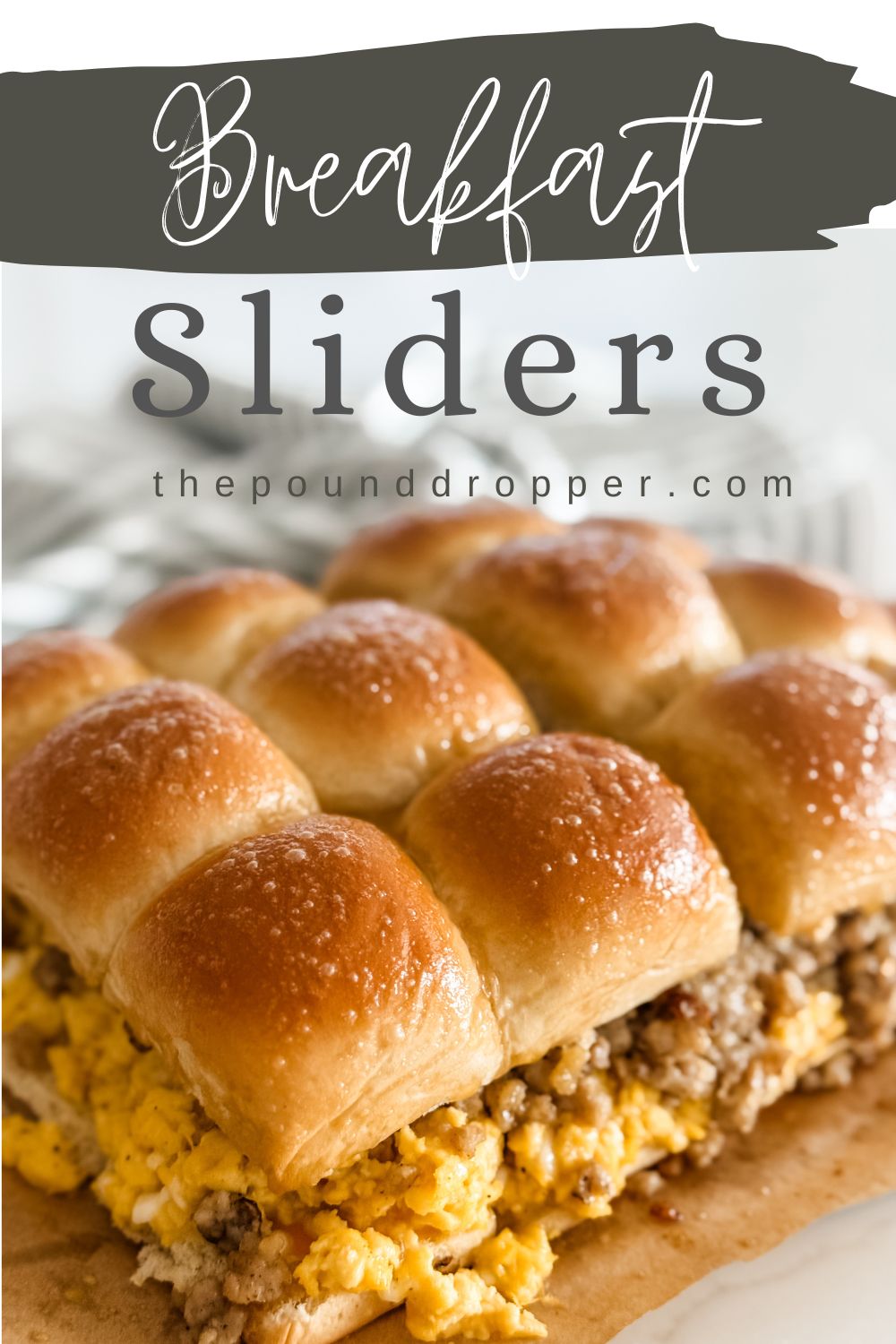 These Easy Breakfast Sliders are packed with breakfast sausage, scrambled eggs mixed with cottage cheese for added fluffiness and protein, cheese, and lathered in a buttery syrup! These make-ahead breakfast sliders take less than 20 minutes to make! Enjoy! via @pounddropper